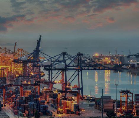 Container Cargo freight ship with working crane bridge in shipyard at dusk for Logistic Import Export background